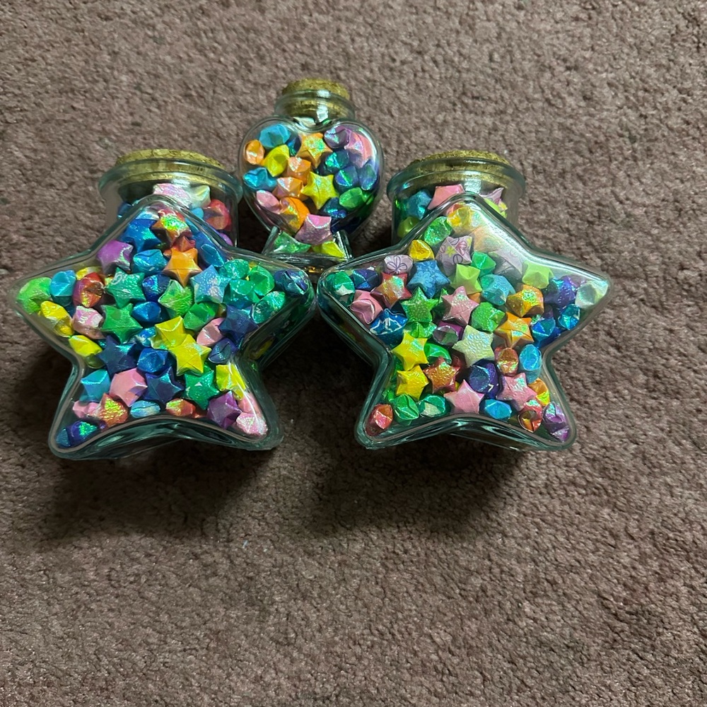 Stars and hearted shaped jars filled with origami lucky stars